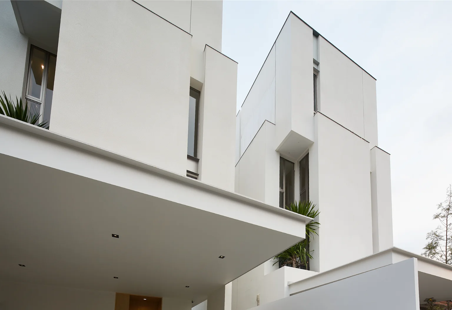 Completed contemporary Bangkok house with a private entrance and garden planting.